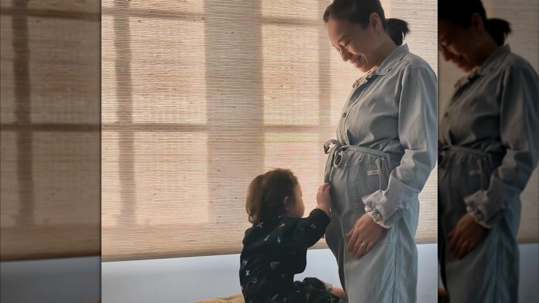 Linda Phan with her son, Parker, touching her baby bump