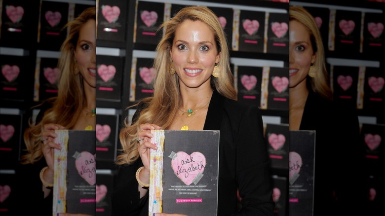 Elizabeth Berkley holding her book