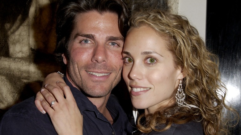 Elizabeth Berkley with her arms around Greg Lauren