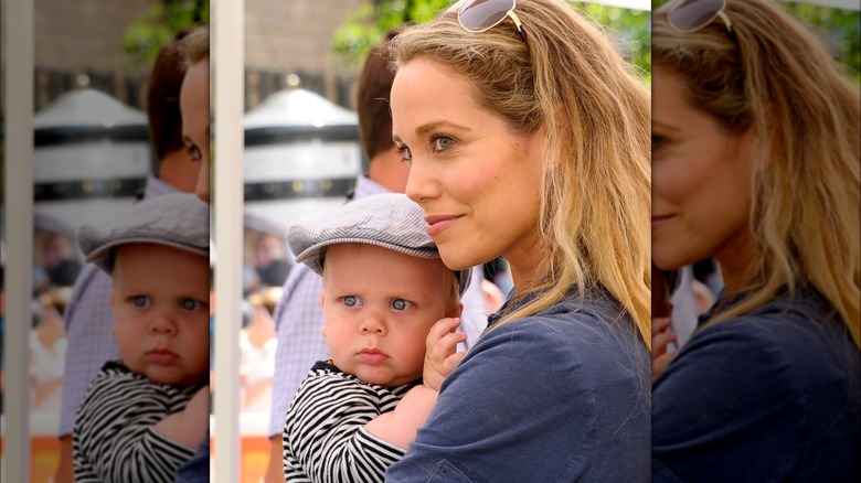 Elizabeth Berkley holding her son Sky