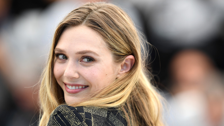 Elizabeth Olsen smiles over her shoulder