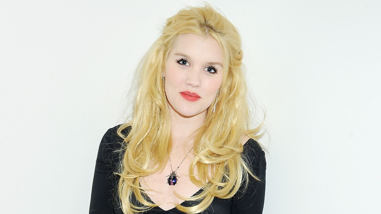 Emerald Fennell posing in front of a white background