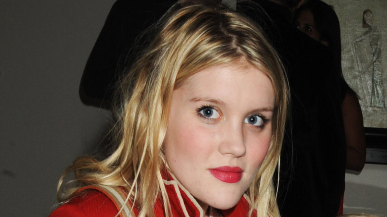 Emerald Fennell wearing a red top