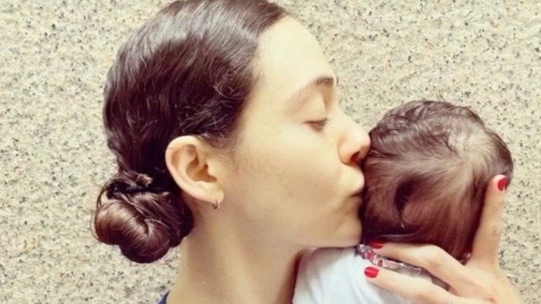 Emmy Rossum kisses daughter's head