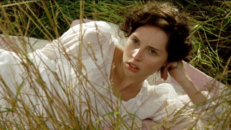 Felicity Jones with her hair up and a headband smiling in "Northanger Abbey" in 2007