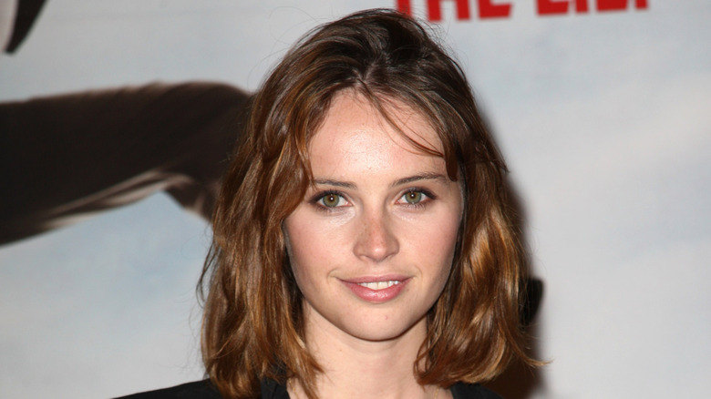 Felicity Jones smiling at a movie premiere in 2009