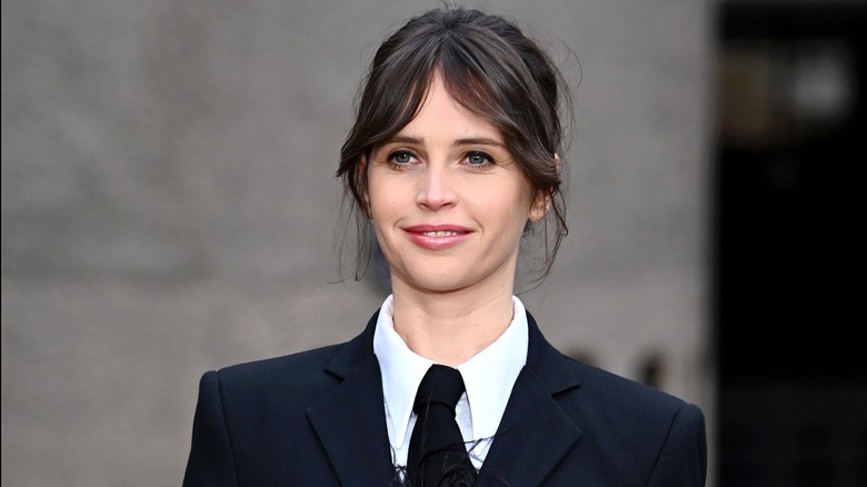 Felicity Jones with curtain bangs smiling at the 2025 premiere for "The Brutalist"