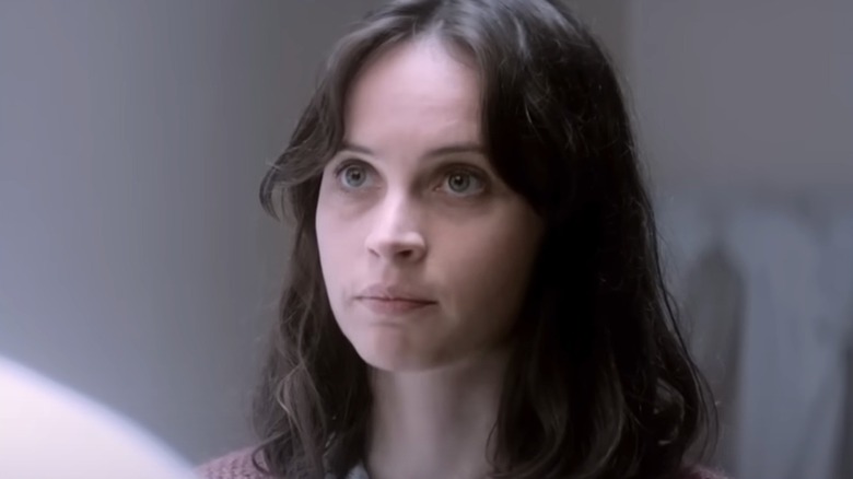 Felicity Jones looking up with a serious expression in The Theory of Everything