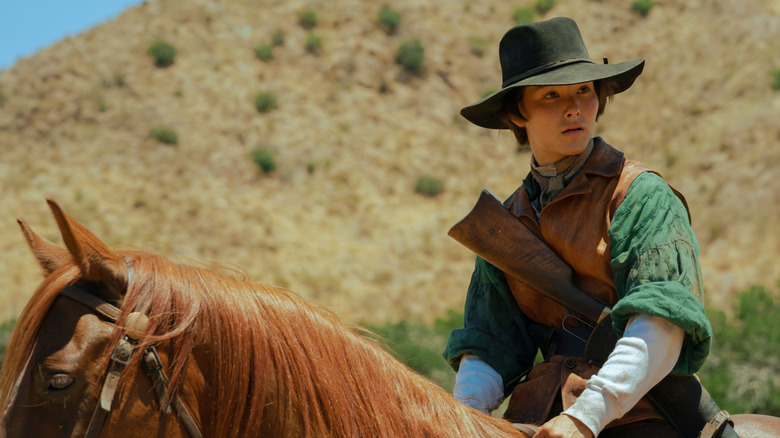 Fivel Stewart riding a horse in a scene from Roar