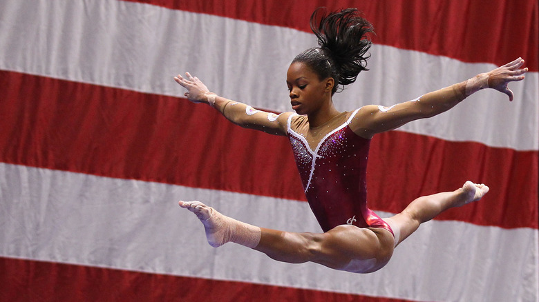 Gabby Douglas performing behind U.S. flag