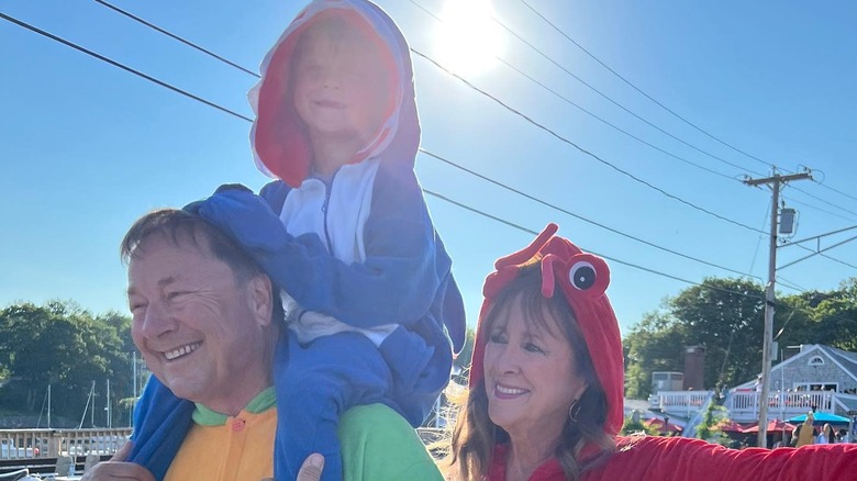 Glen Powell in costume with his parents