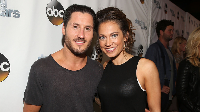 Val Chmerkovskiy and Ginger Zee posing at a DWTS event