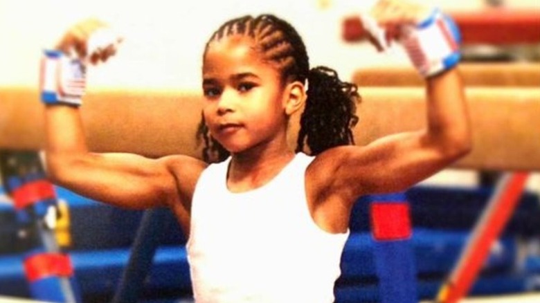 Jordan Chiles flexes her muscles as a child 