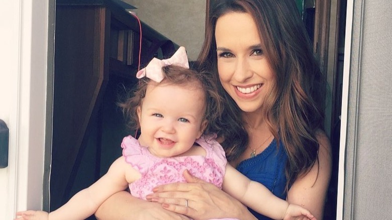 Lacey Chabert posing with daughter on lap