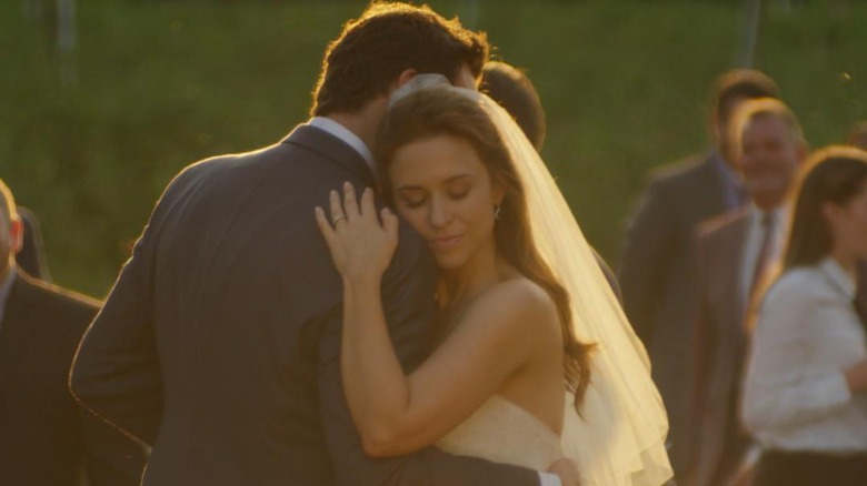 Lacey Chabert in wedding dress hugging man