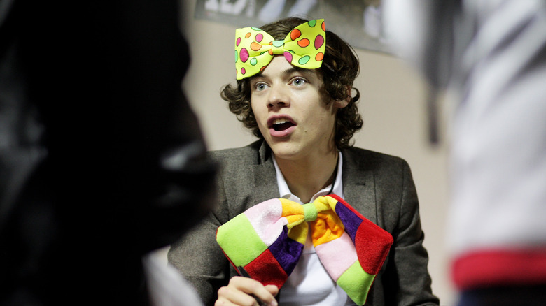 Harry Styles wearing colorful bows