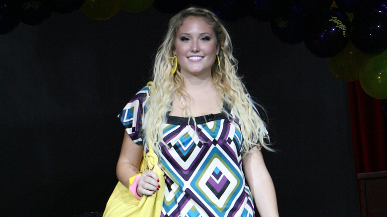 Hayley modelling with patterned dress and yellow bag