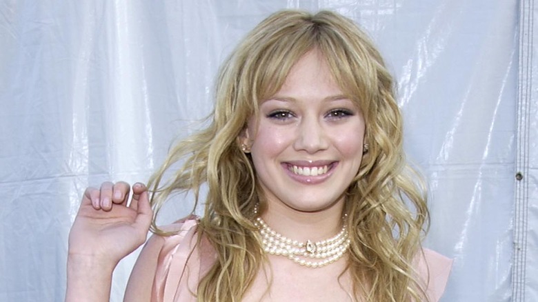 Hilary Duff smiling with curly hair