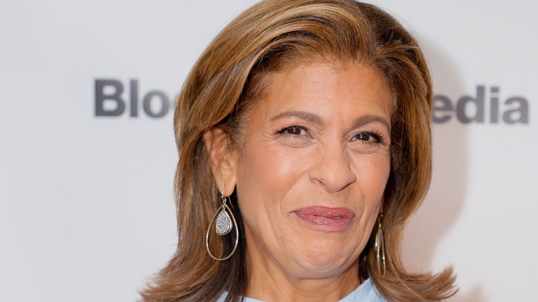 Hoda Kotb smiling and wearing large earrings on the red carpet