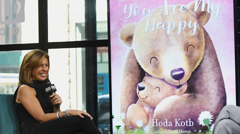 Hoda Kotb sitting at a book press event for her children book