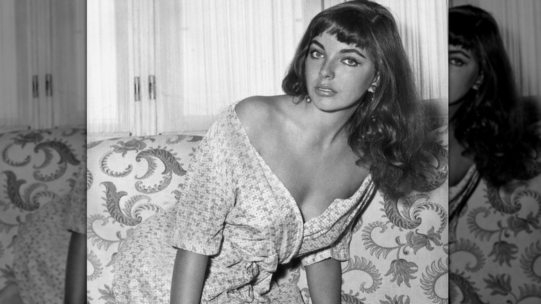 Joan Collins on sofa