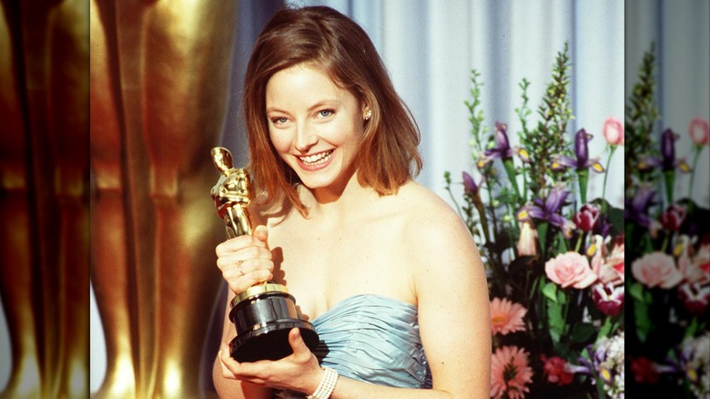 Jodie Foster smiling and holding her first Oscar