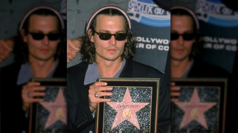 Johnny Depp holding Hollywood star, 1999