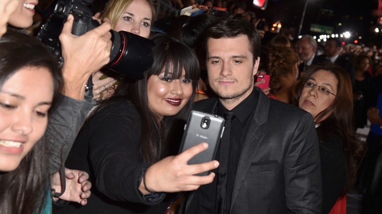 Josh Hutcherson taking a selfie with a fan