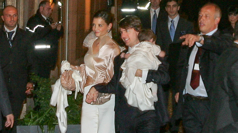 Katie Holmes and Tom Cruise arriving at a restaurant with their daughter