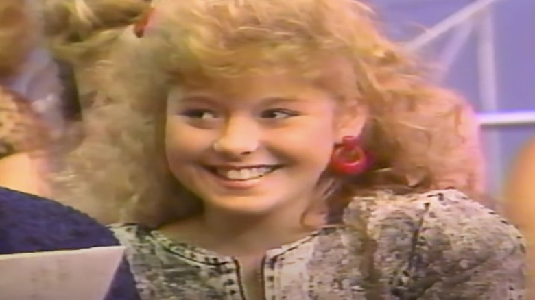 Teenage Kelly Ripa smiling during interview