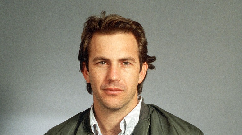 Adult Kevin Costner staring directly into camera