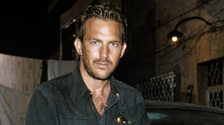 Young Kevin Costner smoldering at camera