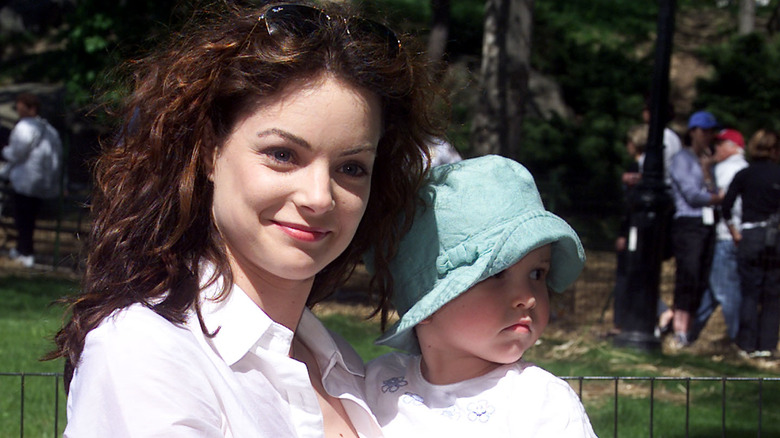 Kimberly Williams-Paisley holding her child