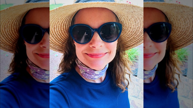 Kimberly Williams-Paisley smiling with a scarf, sunglasses, and hat