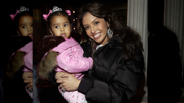 Vanessa Bryant smiling while holding toddler Natalia Bryant