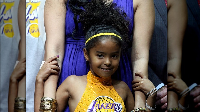 Young Natalia Bryant wearing a sparkly Lakers shirt 