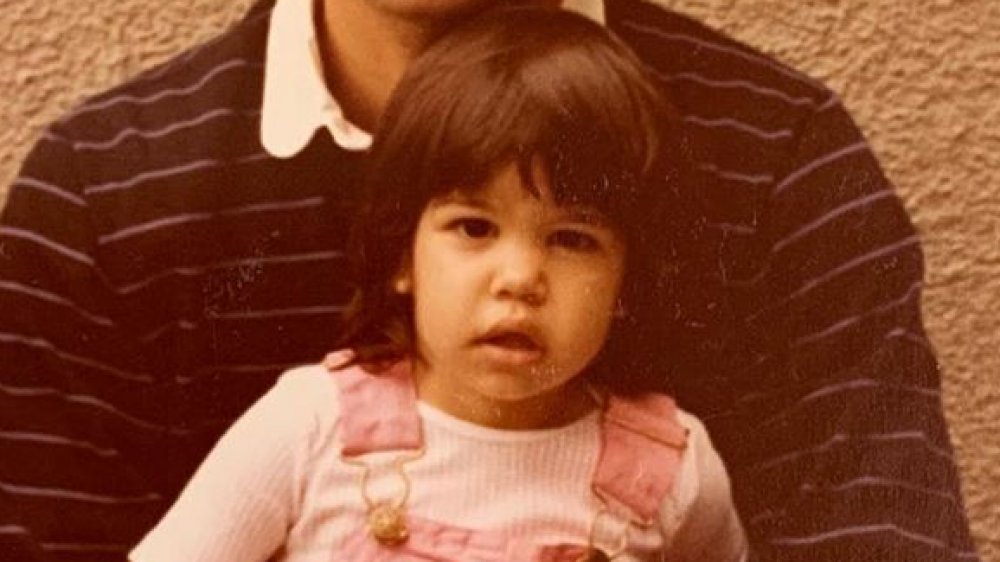 Kourtney Kardashian as a girl with her father, wearing pink