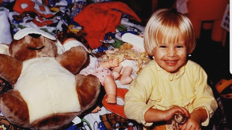 Kristen Bell as a child with toys