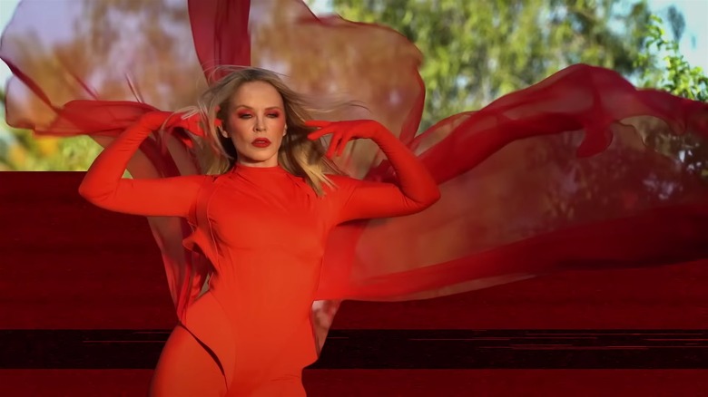 Kylie Minogue red flowing cape Padam Padam video