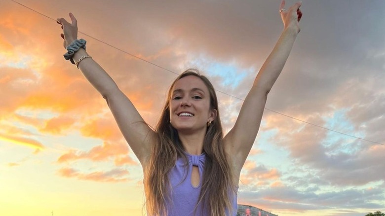 Lady Marina Windsor smiling with arms raised