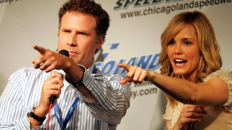 Will Ferrell and Leslie Bibb pointing at their audience