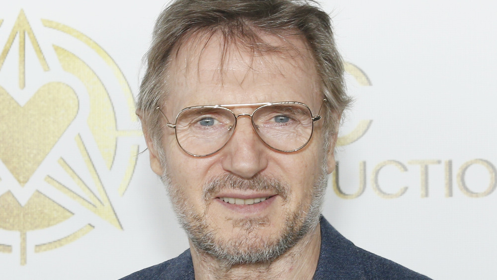 Liam Neeson wearing glasses