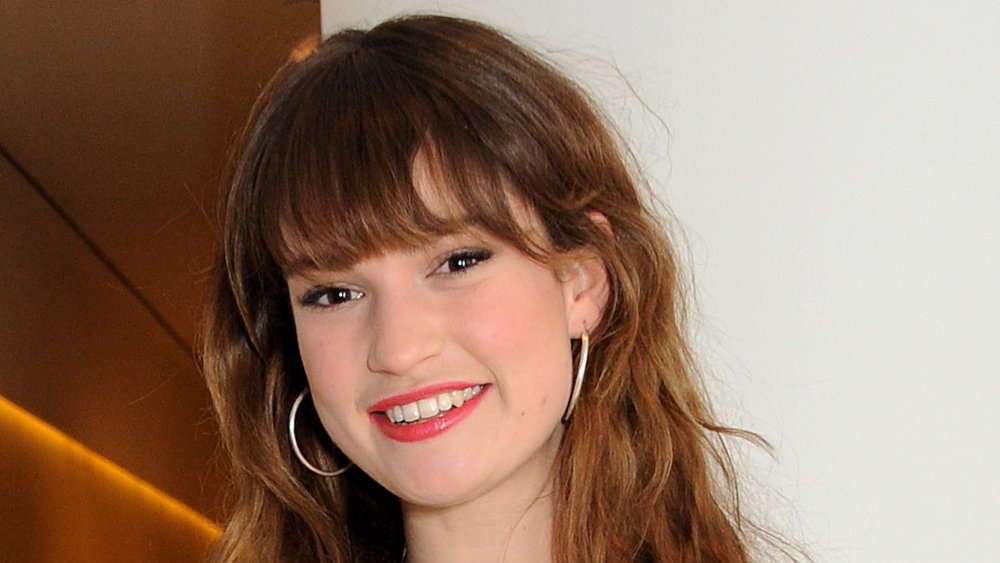 Lily James wearing white, smiling