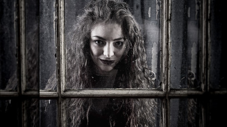 Lorde looking through a door frame 