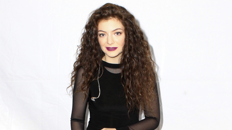 Lorde wearing a black dress