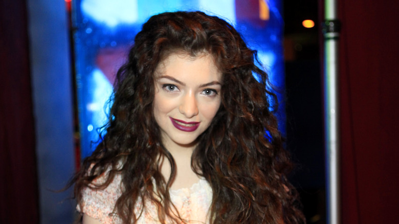 Lorde in front of blue light