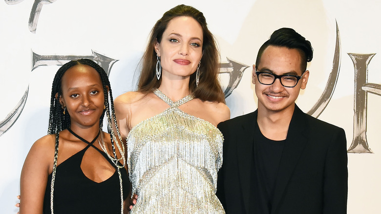 Angelina Jolie, Zahara, and Maddox posing on the red carpet 