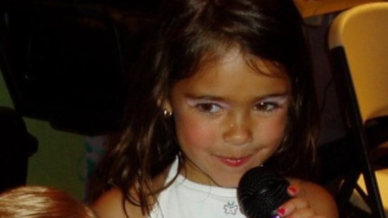 Young Madison Beer with a microphone