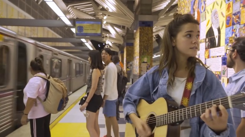 Maia Mitchell singing in a subway station