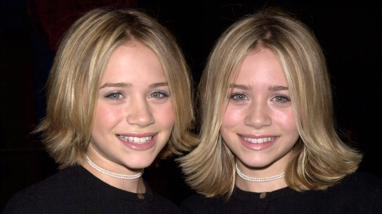 Mary-Kate Olsen posing on the red carpet with her sister